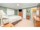 Comfortable bedroom with wood furniture and patterned bedding, adjacent to a bathroom at 1822 Atterbury Ln, Durham, NC 27712
