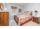 Bedroom showcasing a decorative bed with floral bedding, side table, and a dresser at 1822 Atterbury Ln, Durham, NC 27712