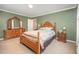 Bedroom featuring a bed with patterned bedding, along with wooden dressers and nightstands at 1822 Atterbury Ln, Durham, NC 27712