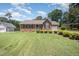 Classic brick home featuring a well-kept lawn and mature landscaping, creating a welcoming curb appeal at 1822 Atterbury Ln, Durham, NC 27712