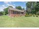 Well-maintained brick home with black shutters, manicured landscaping, and a welcoming front entrance at 1822 Atterbury Ln, Durham, NC 27712