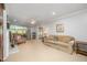 Spacious living room with neutral walls, fireplace, ceiling fan, and ample natural light from large windows at 1822 Atterbury Ln, Durham, NC 27712