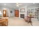 Bright living room featuring a fireplace, built-in bookshelves, and neutral carpeting for a cozy atmosphere at 1822 Atterbury Ln, Durham, NC 27712