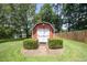A charming, red outbuilding with white trim and a shingled roof, adding character to the landscape at 1822 Atterbury Ln, Durham, NC 27712
