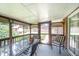 Relaxing screened porch with views of the backyard, complete with seating and a glass table at 1822 Atterbury Ln, Durham, NC 27712