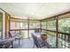 Inviting screened porch featuring comfortable seating and a glass-top table for outdoor dining and relaxation at 1822 Atterbury Ln, Durham, NC 27712
