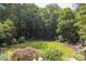 Elevated view of expansive backyard showcasing landscaping and mature trees at 1908 S Lakeshore Dr, Chapel Hill, NC 27514