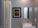 Modern bathroom with a sleek sink, mirror, and walk-in shower with glass enclosure at 1908 S Lakeshore Dr, Chapel Hill, NC 27514