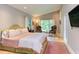 Comfortable bedroom with ample natural light, a cozy seating area, and hardwood floors at 1908 S Lakeshore Dr, Chapel Hill, NC 27514