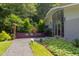 Mid-century modern home featuring a full front window and mature trees at 1908 S Lakeshore Dr, Chapel Hill, NC 27514