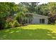 Beautiful home with a modern design, full front windows, landscaped lawn, and mature trees at 1908 S Lakeshore Dr, Chapel Hill, NC 27514