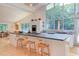 Open-concept kitchen with large island, breakfast bar, and views of the outdoors, perfect for entertaining at 1908 S Lakeshore Dr, Chapel Hill, NC 27514