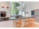 Bright contemporary kitchen featuring a large island, modern appliances, and picturesque views at 1908 S Lakeshore Dr, Chapel Hill, NC 27514