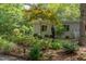 Sculpted landscaping with a statue enhances this modern home's exterior at 1908 S Lakeshore Dr, Chapel Hill, NC 27514