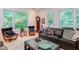 Inviting living room featuring a grandfather clock, leather chairs, and windows with picturesque views at 1908 S Lakeshore Dr, Chapel Hill, NC 27514