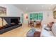 Cozy living room featuring a modern fireplace, comfortable seating, and access to the dining area at 1908 S Lakeshore Dr, Chapel Hill, NC 27514