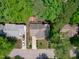 Aerial view of a property showcasing its landscaped yard, deck, neighboring homes, and surrounding greenery at 208 Silk Hope Dr, Cary, NC 27519