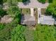 Aerial view of a well maintained single-Gathering home with mature trees and a neat front lawn at 208 Silk Hope Dr, Cary, NC 27519