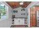 Stylish bar area with geometric wallpaper, wooden ceiling, wine rack, and cabinetry at 208 Silk Hope Dr, Cary, NC 27519