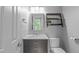 Bright bathroom with a modern vanity, large mirror, and decorative shelving at 208 Silk Hope Dr, Cary, NC 27519