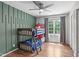 Kid-friendly bedroom with a bunk bed, modern ceiling fan, and natural light at 208 Silk Hope Dr, Cary, NC 27519