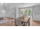Open concept dining area with hardwood floors, modern lighting, and a view to the foyer creating an inviting atmosphere at 208 Silk Hope Dr, Cary, NC 27519