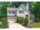 Charming home with beautiful landscaping, well-maintained driveway, and a welcoming front yard at 208 Silk Hope Dr, Cary, NC 27519