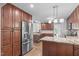 Modern kitchen featuring stainless steel appliances, granite countertops, and ample cabinetry creating an efficient workspace at 208 Silk Hope Dr, Cary, NC 27519
