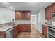 Well-equipped kitchen with granite countertops, stainless steel appliances, and hardwood floors creating a functional space at 208 Silk Hope Dr, Cary, NC 27519