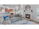 Cozy living space featuring a fireplace, large windows, and seamless flow into the adjacent kitchen for easy entertaining at 208 Silk Hope Dr, Cary, NC 27519
