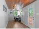 Cozy office space with wood ceiling, fan, natural light, and access to an outdoor deck at 208 Silk Hope Dr, Cary, NC 27519