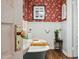 Charming bathroom featuring a vintage-style tub, floral wallpaper, and unique decorative touches at 210 Peachtree St, Roxboro, NC 27573