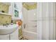 Cozy bathroom with a shower-tub combination and a window that lets in natural light at 210 Peachtree St, Roxboro, NC 27573