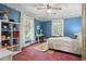 Cozy bedroom with soft pink carpet, built-in shelves, and two windows with natural light at 210 Peachtree St, Roxboro, NC 27573