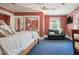 Spacious bedroom features red wallpaper, bright window, and comfortable sitting area at 210 Peachtree St, Roxboro, NC 27573
