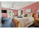 Comfortable bedroom with beautiful red patterned wallpaper and natural light at 210 Peachtree St, Roxboro, NC 27573