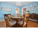 Inviting dining room with wooden floors, chandelier and seating for six at 210 Peachtree St, Roxboro, NC 27573