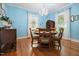 Well lit dining room with hardwood floors, wainscoting, and chandelier at 210 Peachtree St, Roxboro, NC 27573