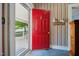 Bright red front door and wallpapered foyer create a warm and inviting first impression at 210 Peachtree St, Roxboro, NC 27573