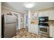 Practical kitchen with stainless steel appliances and stairs to another level at 210 Peachtree St, Roxboro, NC 27573
