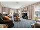 Cozy living room features a piano and traditional decor, offering a comfortable and inviting space at 210 Peachtree St, Roxboro, NC 27573