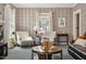 Comfortable living room with lots of natural light and vintage design at 210 Peachtree St, Roxboro, NC 27573