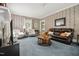 Spacious living room decorated with traditional wallpaper and stylish furnishings, creating a comfortable space at 210 Peachtree St, Roxboro, NC 27573