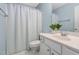 Well-lit bathroom with white cabinets, a mirror, and a shower with curtain at 2106 White Pond Ct, Apex, NC 27523