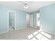 Spacious bedroom with blue walls, carpet floors, two closets, and an ensuite bathroom at 2106 White Pond Ct, Apex, NC 27523