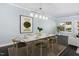 Bright dining room with seating for six, modern lighting, and a neutral color palette at 2106 White Pond Ct, Apex, NC 27523