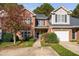 Traditional brick home with a well-maintained lawn, attached garage, and beautiful landscaping at 2106 White Pond Ct, Apex, NC 27523