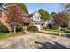 Inviting home exterior with lush landscaping, a driveway, and an attached garage at 2106 White Pond Ct, Apex, NC 27523