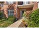 Brick home's inviting front entrance with a glass door, tidy landscaping, and a paved walkway at 2106 White Pond Ct, Apex, NC 27523