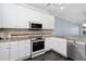 Bright kitchen featuring white cabinets, granite countertops, stainless steel appliances, and tiled backsplash at 2106 White Pond Ct, Apex, NC 27523